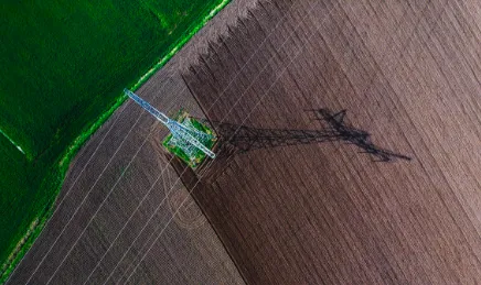 Birds eye view of an electricity pylon in a field